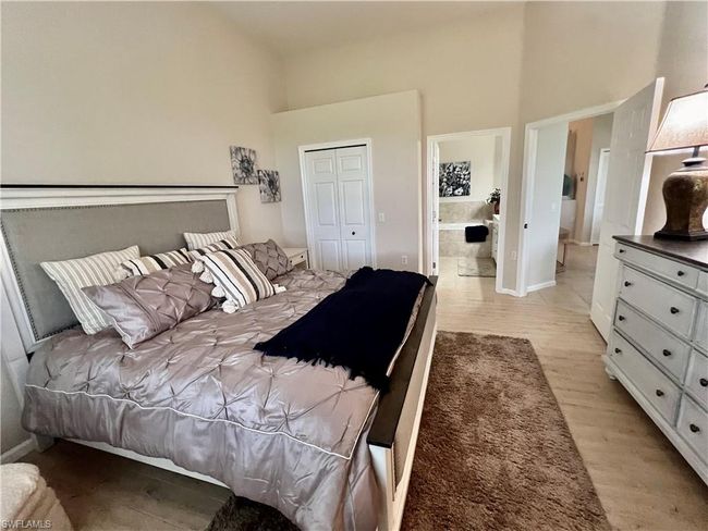 Primary bathroom and closet off of the bedroom before furniture removed | Image 22