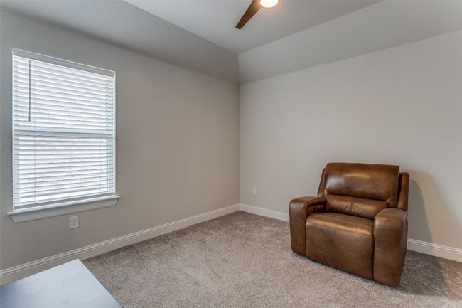 Living area with ceiling fan, carpet, and lofted ceiling | Image 16