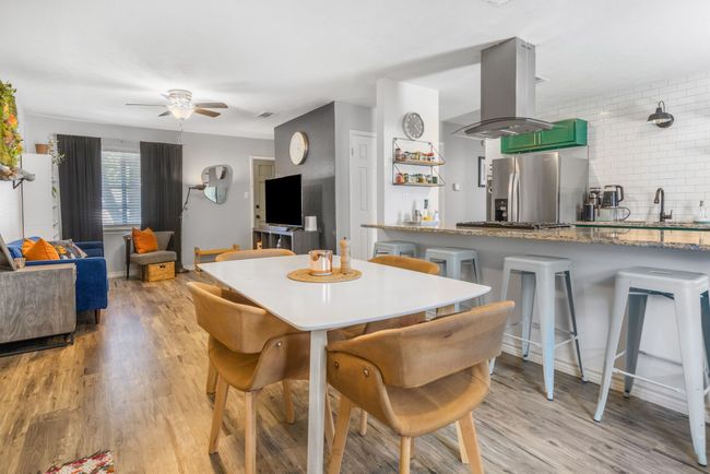 Dining area with ceiling fan and light wood-style floors | Image 10