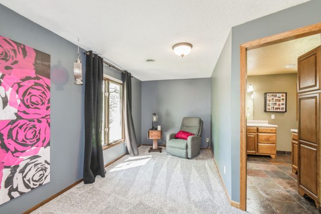 View of the private seating area in the primary bedroom and the 3/4 bathroom! | Image 29
