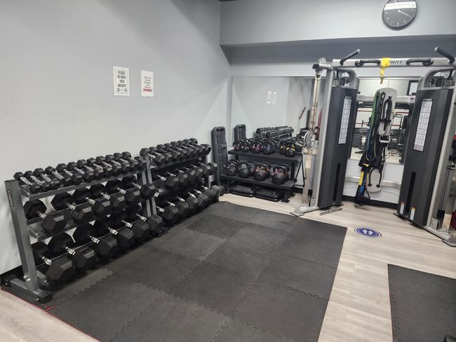Workout area with wood finished floors | Image 11