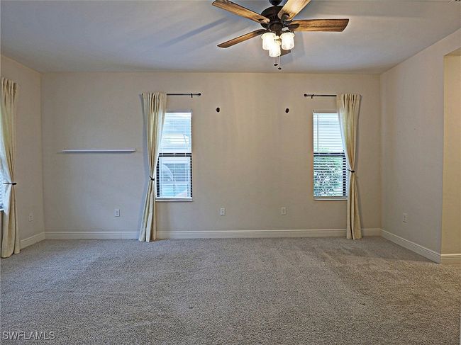 Spare room featuring carpet, a ceiling fan, and baseboards | Image 13