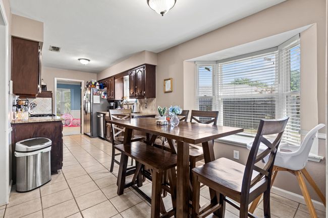 Dining area featuring plenty of natural light and light tile patterned floors | Image 9