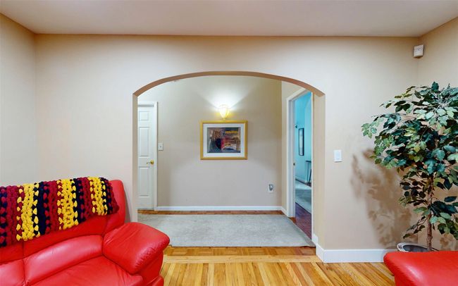 Sitting room featuring arched walkways, baseboards, and wood finished floors | Image 26