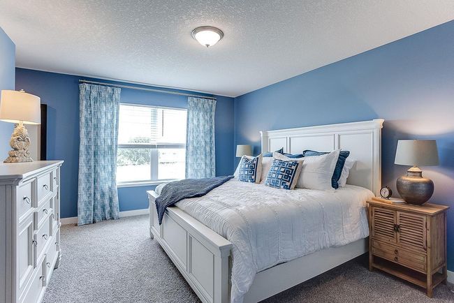 An oasis of its own, the primary suite offers the perfect escape. There's immediate access to a private bathroom that features dual sinks and a large shower. Photo is of model home. Colors and options may vary. Ask Sales Agent for details. | Image 23