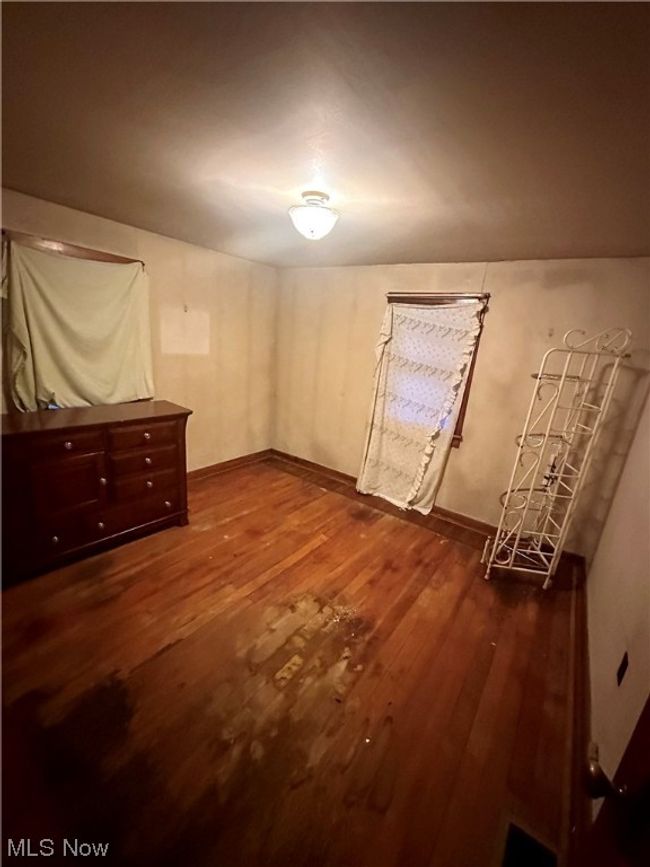 Unfurnished bedroom with dark wood-type flooring | Image 14