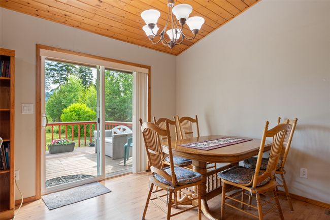 Dining space with wood ceiling, a chandelier, wood finished floors, and lofted ceiling | Image 25