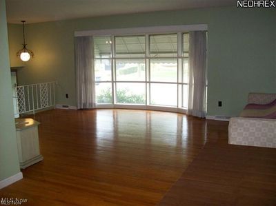 Large living room with dark hardwood / wood-style floors | Image 3