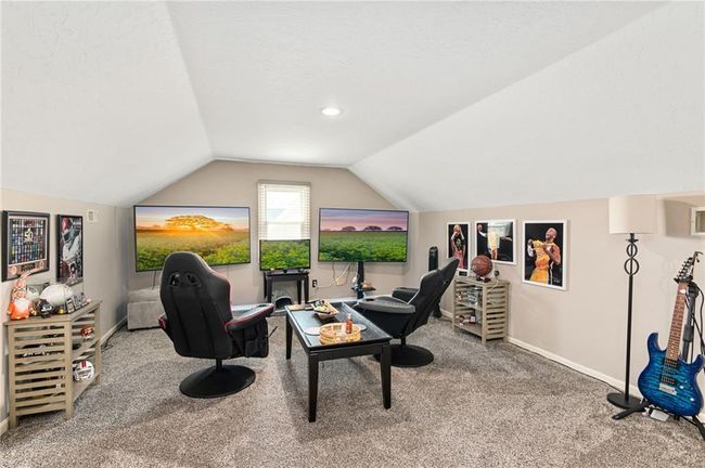 Carpeted office space with vaulted ceiling and a textured ceiling | Image 40