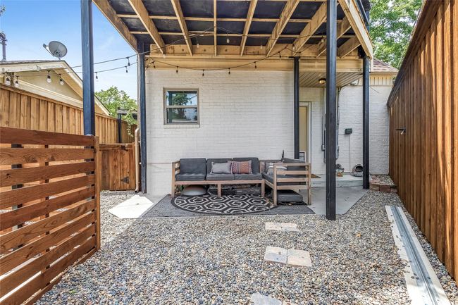 View of patio with outdoor lounge area and a gate | Image 33