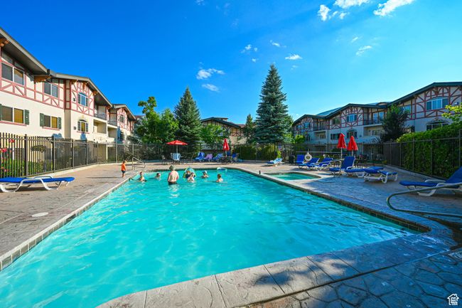 Pool with a patio area, a residential view, and fence | Image 34
