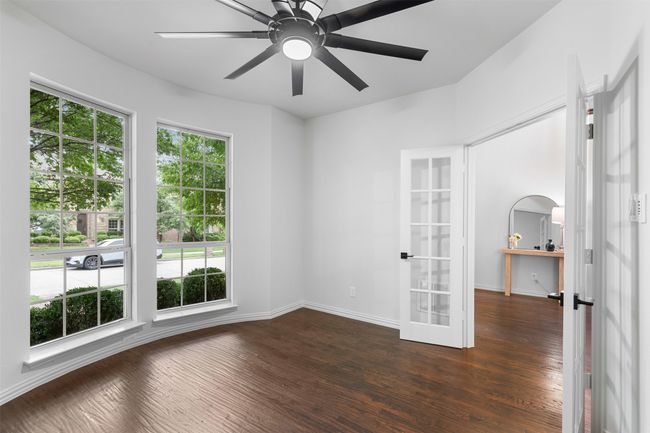 Unfurnished room with dark wood-style flooring, french doors, a ceiling fan, and baseboards | Image 9