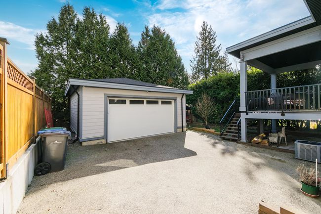 Detached garage featuring central AC, fence, and driveway | Image 39