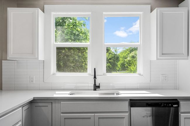 Kitchen featuring dishwasher, backsplash, and light countertops | Image 5