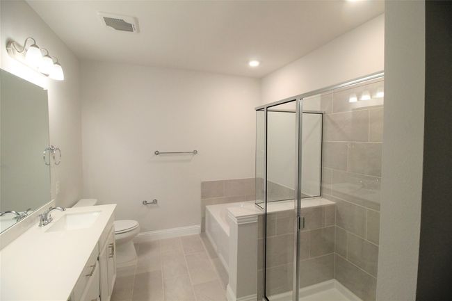 Primary Full bathroom with toilet, a stall shower, vanity, and a bath | Image 10