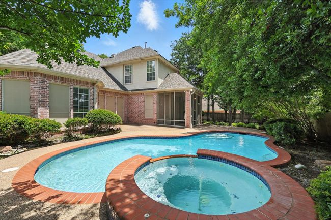 View of pool featuring a sunroom, a pool with connected hot tub, and a patio | Image 26