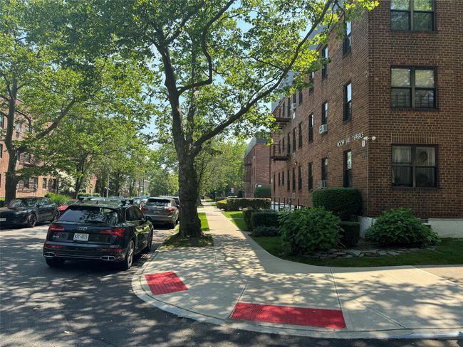 View of asphalt road with sidewalks and curbs | Image 4