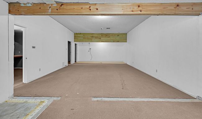 Below grade area featuring carpet floors, baseboards, and a textured ceiling | Image 8
