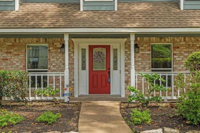 Charming front porch offering a perfect spot to relax and enjoy the outdoors. | Image 2