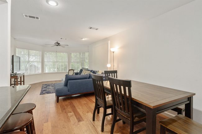Dining space featuring light wood finished floors, ceiling fan, and recessed lighting | Image 11