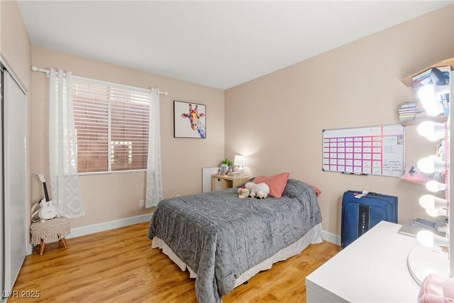 Bedroom featuring wood finished floors, baseboards, and a closet | Image 33