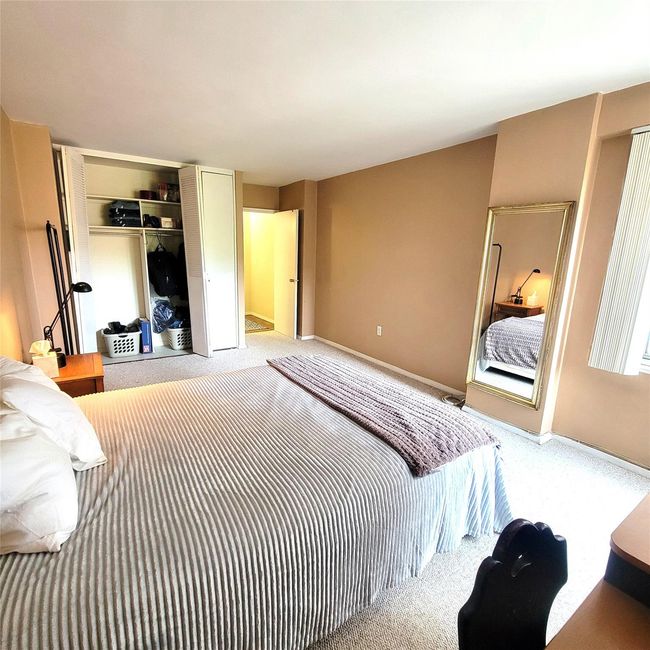 Carpeted bedroom with a closet and baseboards | Image 11