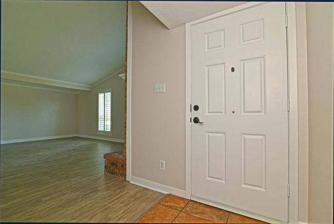 Foyer entrance featuring lofted ceiling, baseboards, and wood finished floors | Image 4