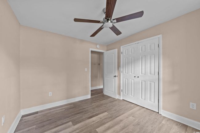 Unfurnished bedroom with wood finished floors, a closet, and ceiling fan | Image 31