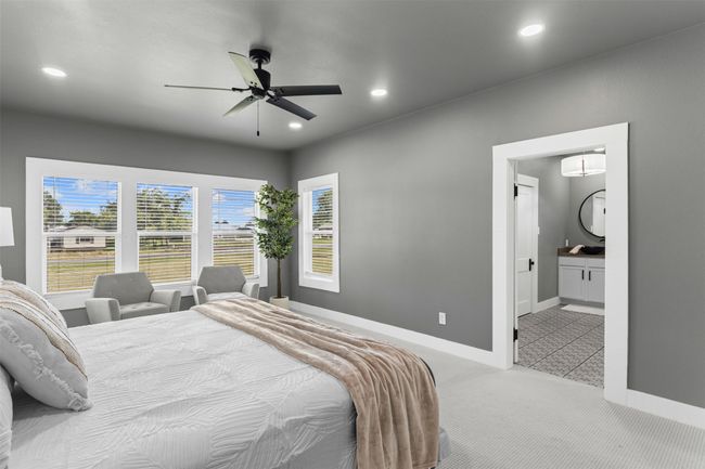 Bedroom with carpet floors, recessed lighting, baseboards, ensuite bath, and ceiling fan | Image 23