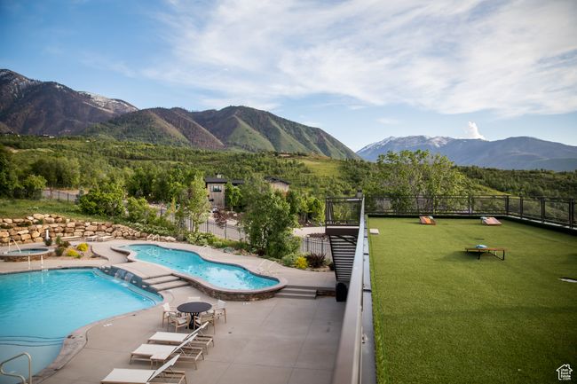 Community pool featuring a mountain view and a patio area | Image 14