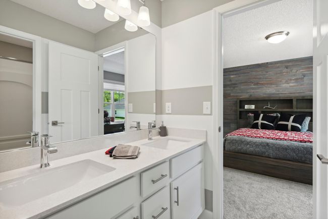 (Photo of decorated model, similar floor plan, colors, finishes and features will vary) The convenient, well-designed dual entry bathroom features a double-vanity with separate shower/tub area, offering two private spaces. | Image 18