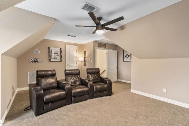 Behind the media chairs, an attic access door makes it convenient for getting to the attic space. | Image 31