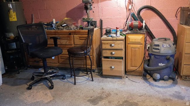 Basement featuring unfinished concrete floors. | Image 44