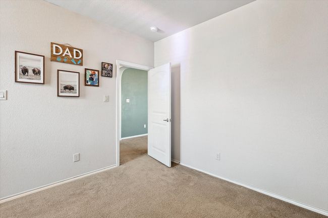 Carpeted spare room featuring arched walkways and baseboards | Image 23