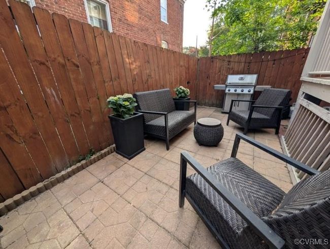View of patio with a fenced backyard, an outdoor living space, and a grill | Image 36