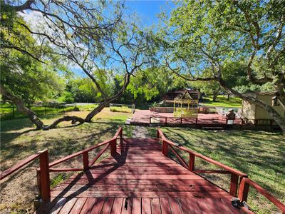 Backyard, swing, storage room, sink for cleaning fish or making your favorite drink, canal that leads to the main lake. | Image 3