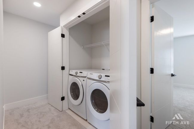 Laundry area featuring light carpet, washing machine and clothes dryer, and recessed lighting | Image 29