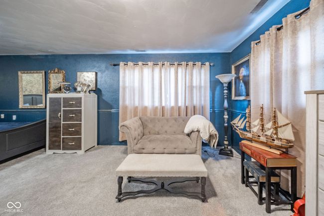 living area with visible vents and carpet floors | Image 11