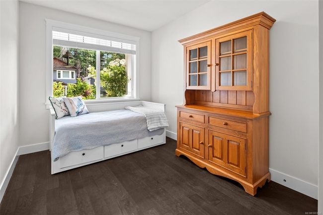 Bedroom with dark wood-style floors and baseboards | Image 7