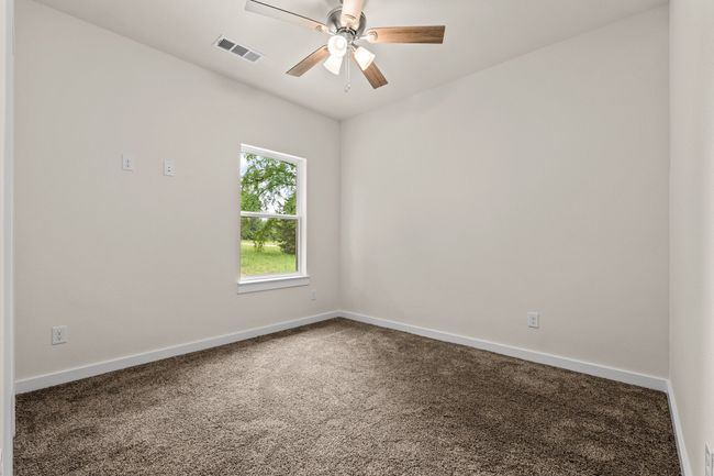 Spare Bedroom with carpet flooring, baseboards, and a ceiling fan | Image 26