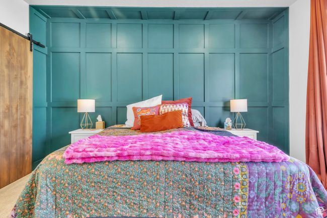 Bedroom with a decorative wall and a barn door | Image 18