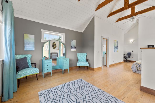 Living area with hardwood / wood-style floors, vaulted ceiling with beams, ceiling fan | Image 15