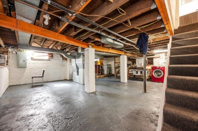 Basement with stairway, electric panel, and washing machine and dryer | Image 17