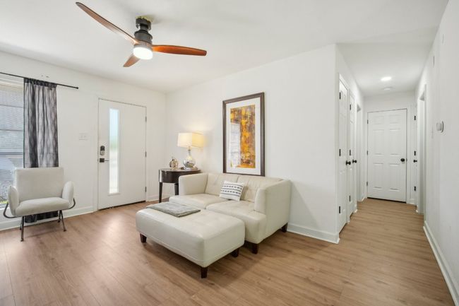 Living area looking down hallway towards bedrooms. | Image 16