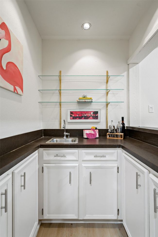 Dry bar with recessed lighting, white cabinets, and dark countertops | Image 5