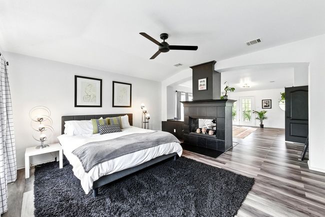 Bedroom featuring baseboards, ceiling fan, light wood-style flooring, and visible vents | Image 17