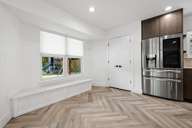 Kitchen with recessed lighting, stainless steel fridge with ice dispenser, dark brown cabinetry, and a healthy amount of sunlight | Image 19