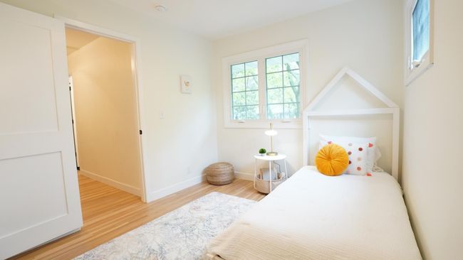 The third upper level bedroom is on the other side of the hall bath from the second bedroom and features ample natural light, a new light fixture and refinished hardwood floors. | Image 27