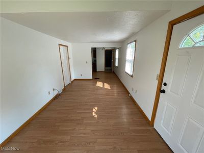 Hall with hardwood / wood-style flooring and a textured ceiling | Image 3