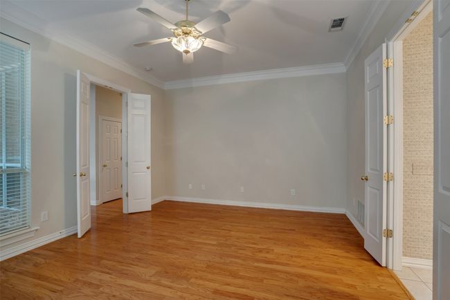 Unfurnished bedroom with light wood-style flooring, baseboards, ornamental molding, and a ceiling fan | Image 18